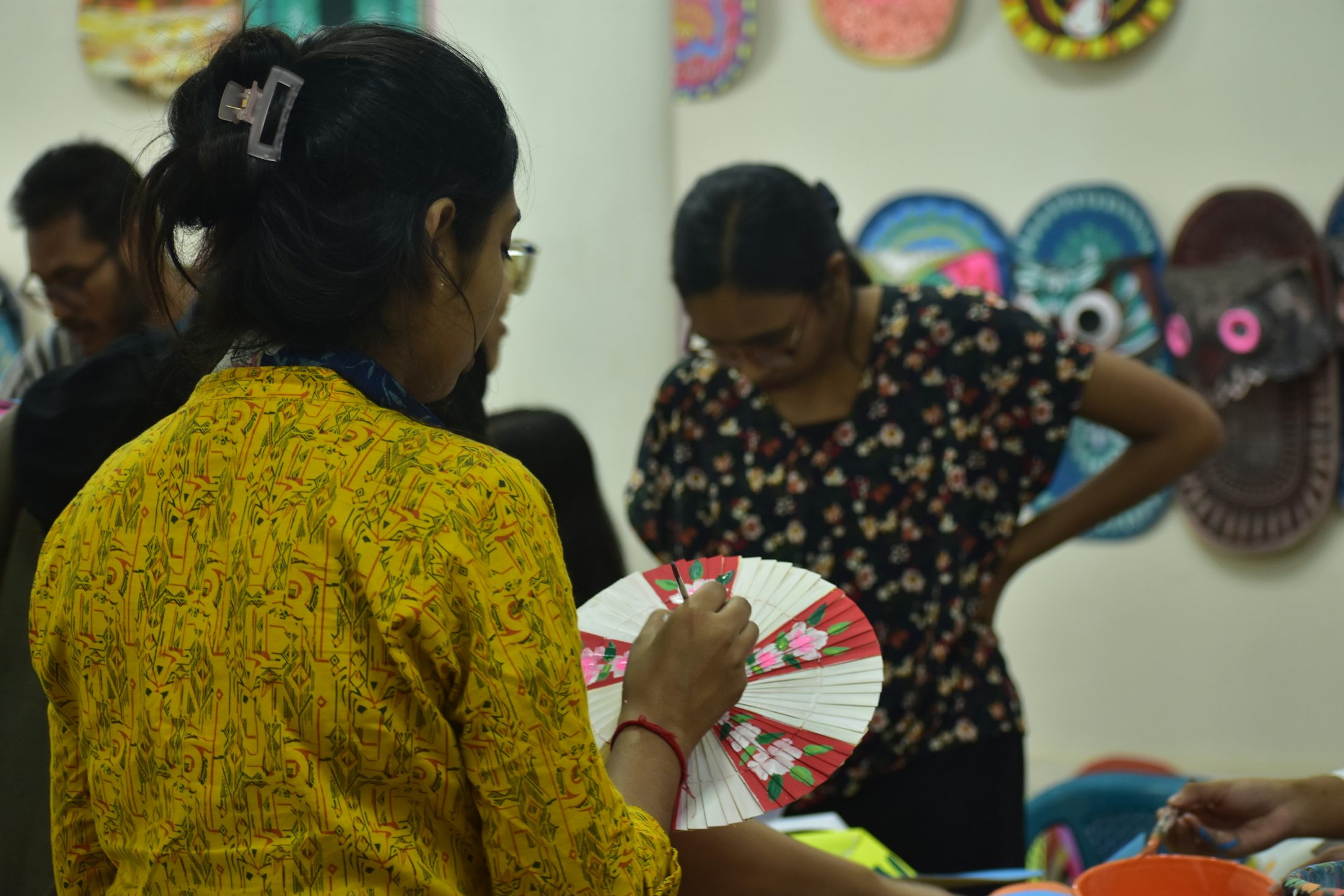 Decorated fan being painted for a Bengali cultural event